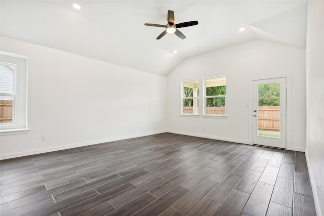 spare room with vaulted ceiling, baseboards, and wood finish floors