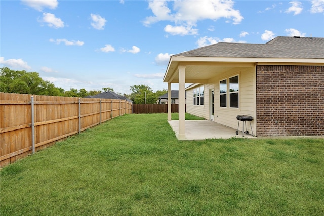 view of yard with a patio and a fenced backyard