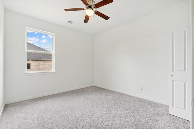 unfurnished room featuring a ceiling fan, carpet flooring, baseboards, and visible vents