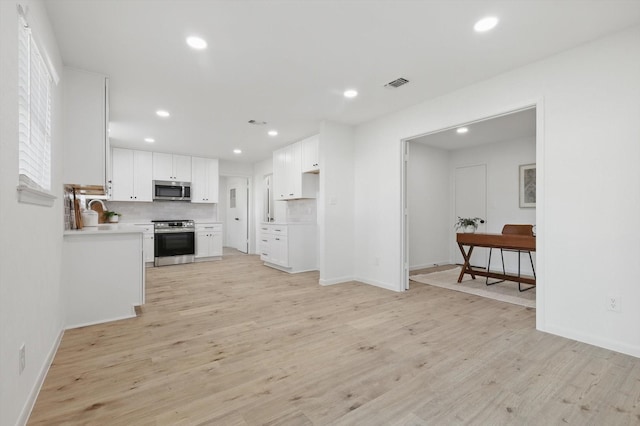 kitchen with visible vents, recessed lighting, appliances with stainless steel finishes, light wood-style floors, and white cabinetry