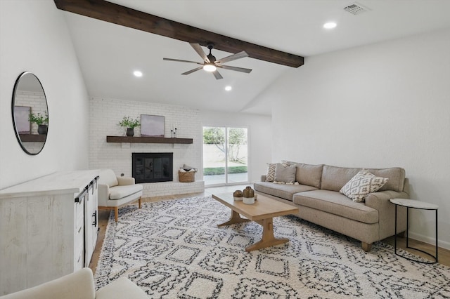 living room with recessed lighting, visible vents, a fireplace, and vaulted ceiling with beams