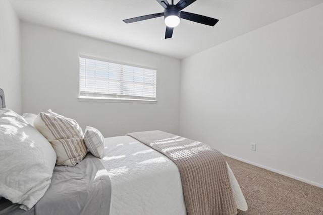 carpeted bedroom featuring a ceiling fan and baseboards