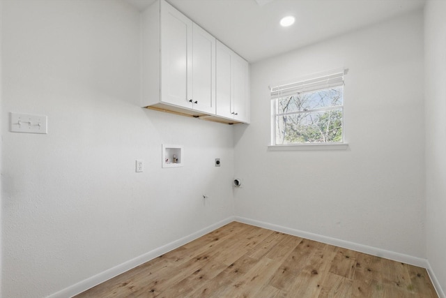 laundry area featuring hookup for a washing machine, baseboards, hookup for an electric dryer, light wood-style flooring, and cabinet space