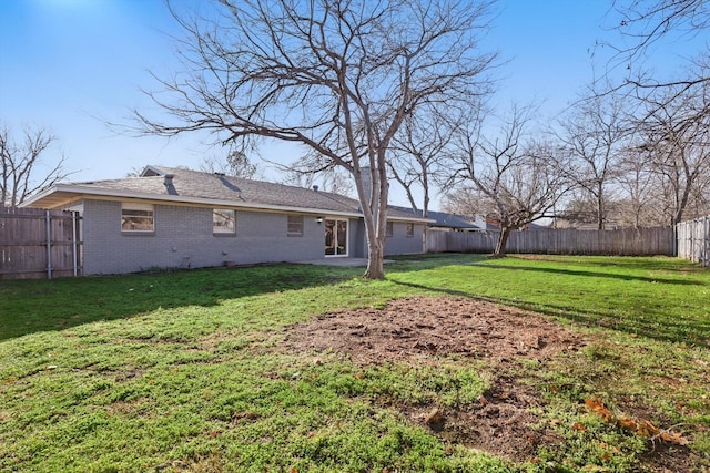 view of yard with a fenced backyard