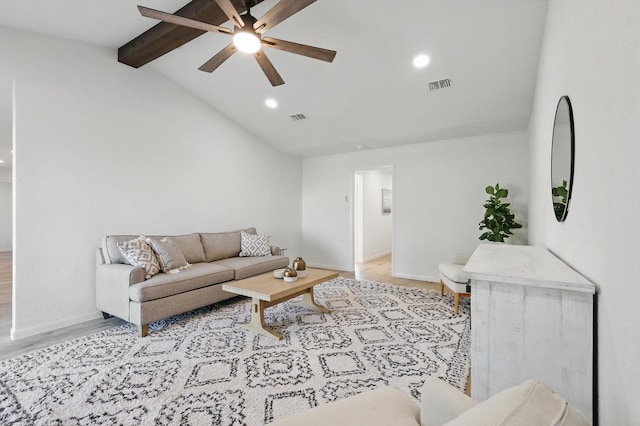 living area featuring wood finished floors, vaulted ceiling with beams, a ceiling fan, and visible vents