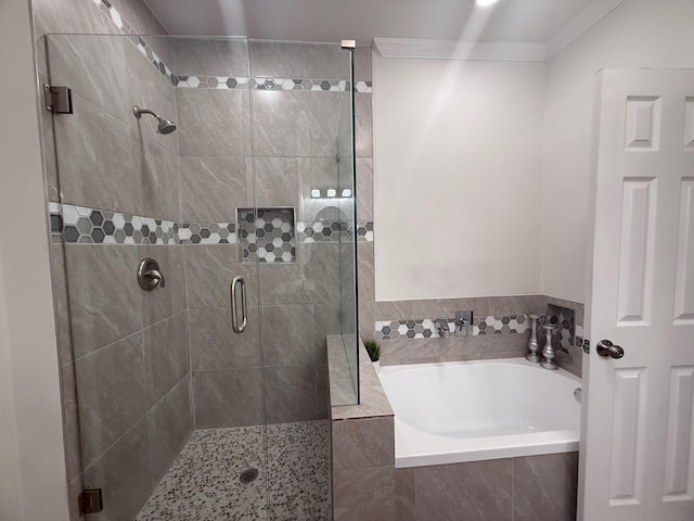 full bath with a shower stall, a garden tub, and ornamental molding