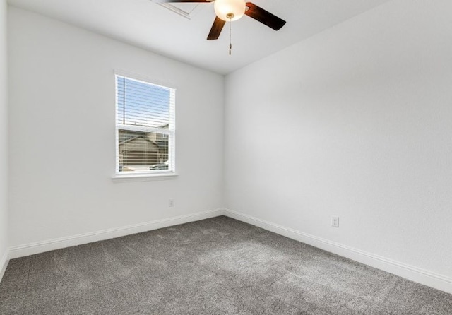 spare room featuring baseboards, a ceiling fan, and dark carpet