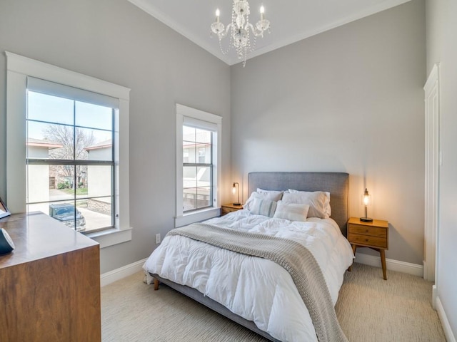 bedroom with lofted ceiling, light colored carpet, baseboards, and a chandelier