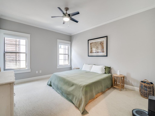 bedroom with baseboards, carpet floors, ceiling fan, and crown molding