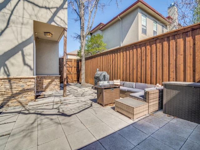 view of patio / terrace with an outdoor hangout area, a fenced backyard, and a gate