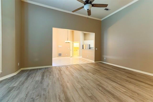 unfurnished room featuring light wood-type flooring, visible vents, ornamental molding, and ceiling fan with notable chandelier