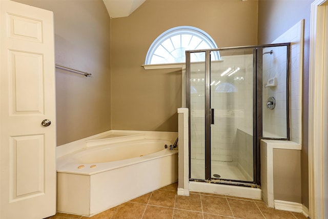 full bath with tile patterned floors, a bath, and a shower stall