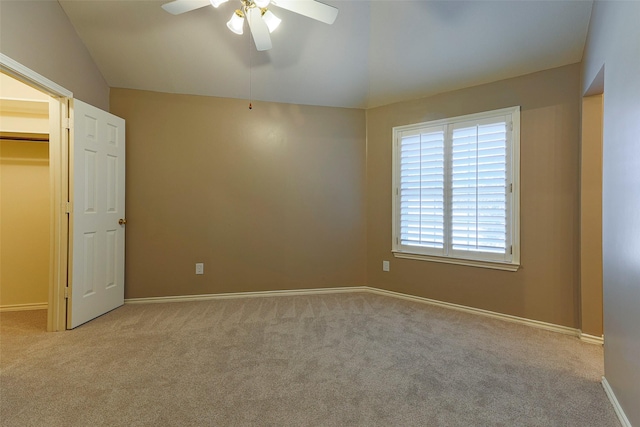 interior space with baseboards, ceiling fan, and vaulted ceiling