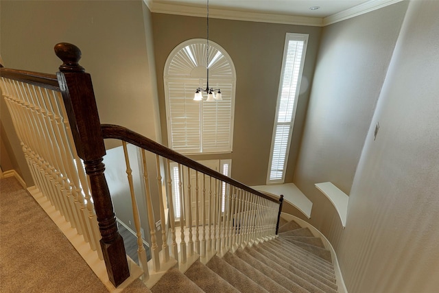 stairs featuring carpet flooring, baseboards, a chandelier, and ornamental molding