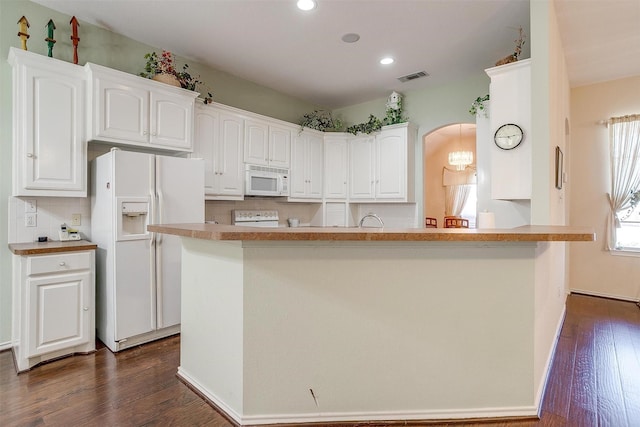 kitchen featuring visible vents, white appliances, dark wood-style floors, and white cabinets