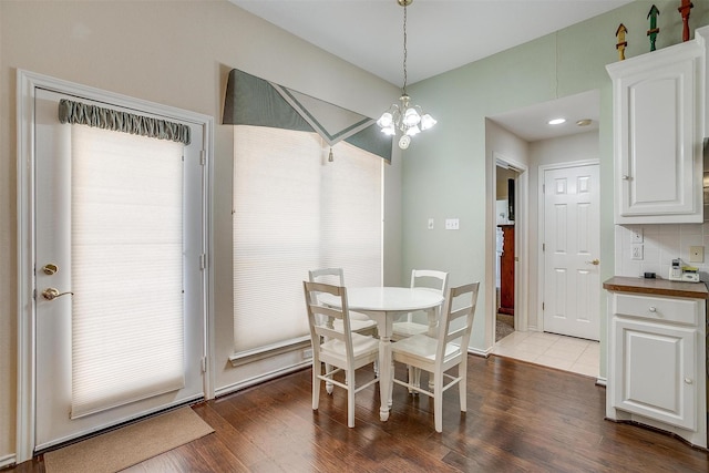 dining area with a notable chandelier and dark wood-style floors