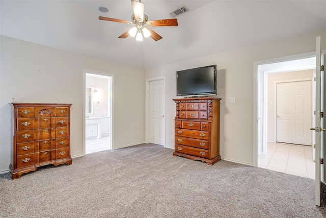 bedroom featuring ensuite bath, vaulted ceiling, visible vents, and carpet floors