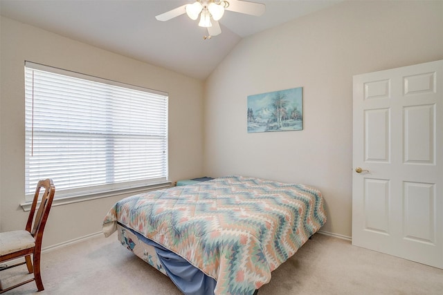 carpeted bedroom featuring ceiling fan, baseboards, and lofted ceiling