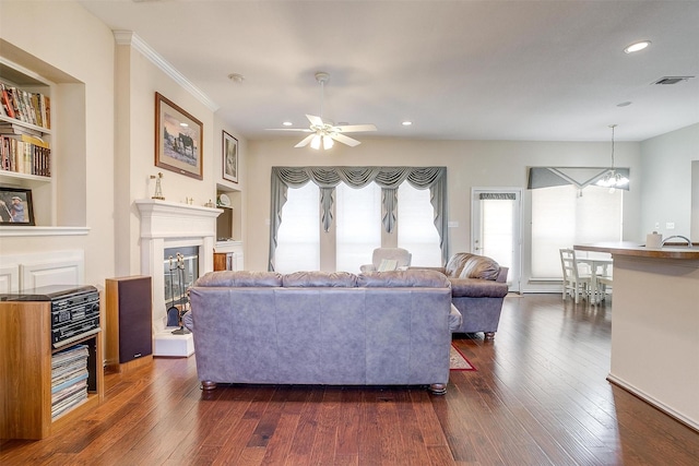 living area with recessed lighting, visible vents, dark wood-style floors, and a fireplace