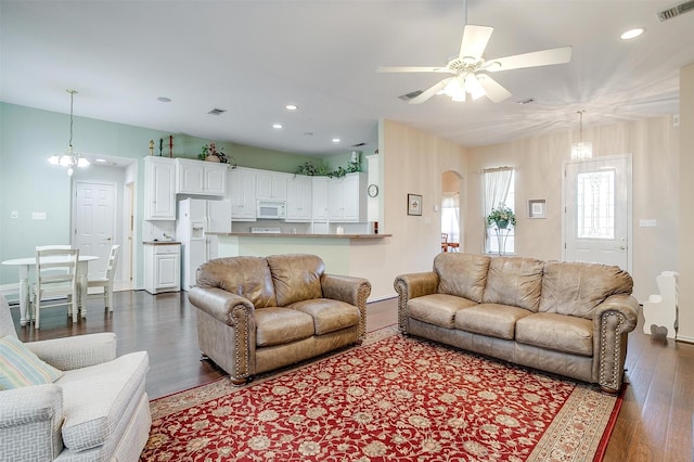 living room featuring visible vents, a ceiling fan, dark wood-style floors, recessed lighting, and arched walkways