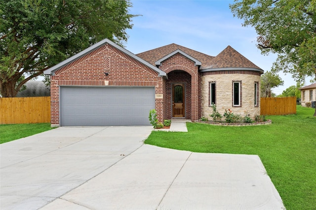 view of front facade with brick siding, driveway, a garage, and fence