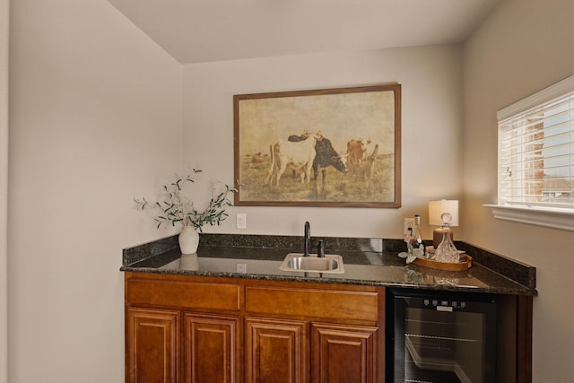 bar featuring beverage cooler, wet bar, and a sink