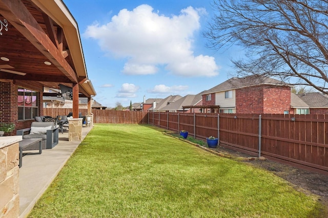 view of yard featuring a patio, a fenced backyard, and a residential view