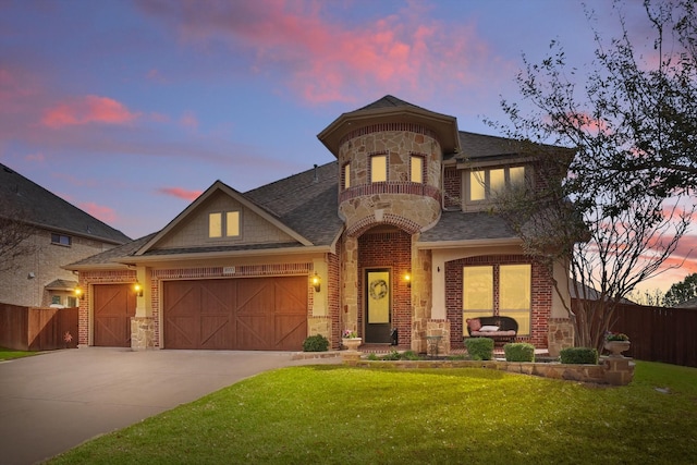 view of front of house with driveway, a balcony, fence, an attached garage, and brick siding