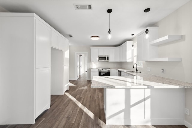 kitchen featuring visible vents, a peninsula, open shelves, a sink, and stainless steel appliances