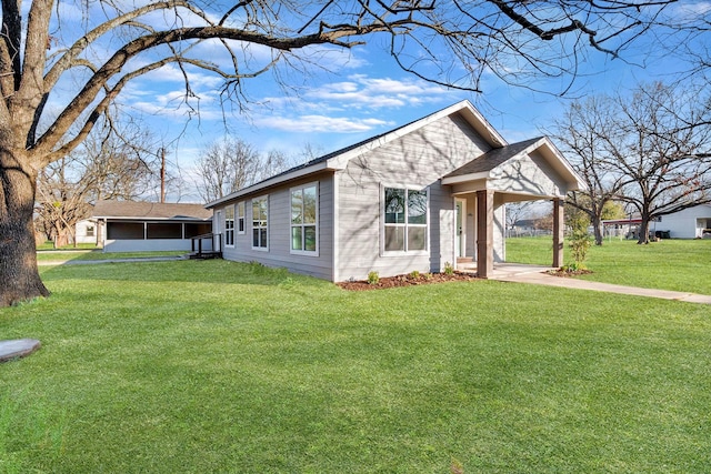 view of property exterior featuring a yard and a sunroom