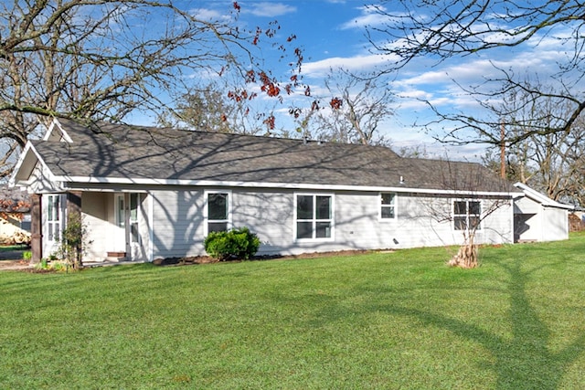 rear view of house featuring a yard