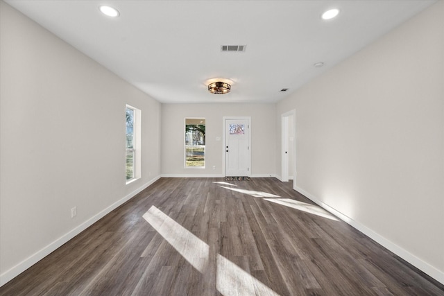 entrance foyer featuring dark wood-style floors, visible vents, and baseboards