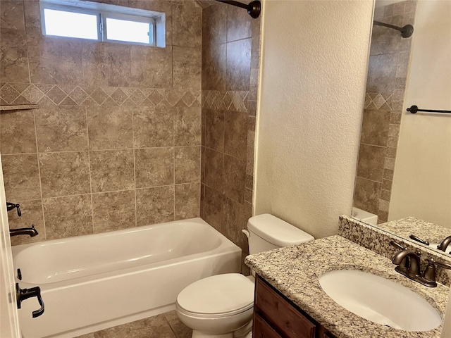 bathroom with vanity, tile patterned floors, toilet, a textured wall, and shower / bathtub combination