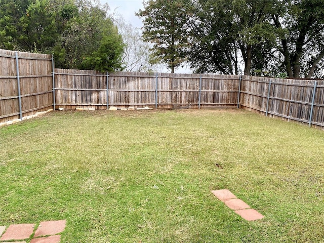 view of yard with a fenced backyard