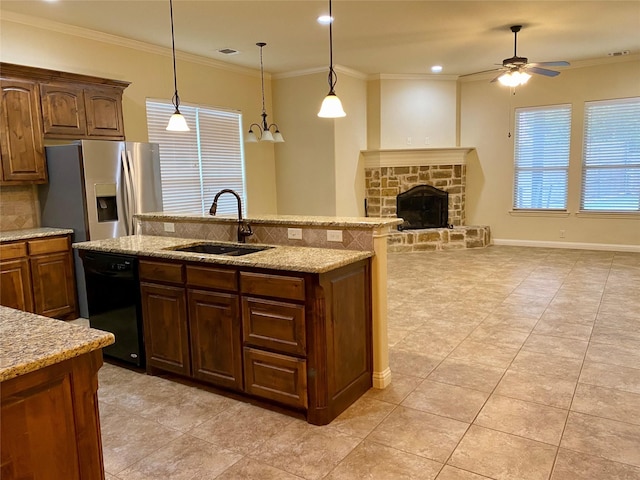 kitchen featuring a sink, stainless steel fridge, a fireplace, crown molding, and dishwasher