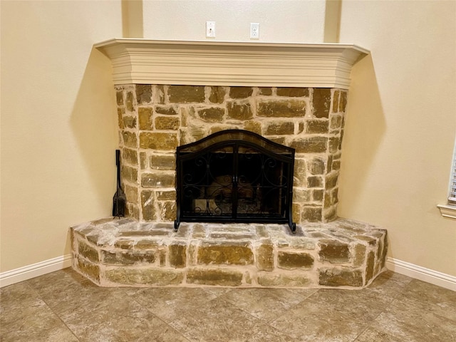 room details featuring a fireplace and baseboards