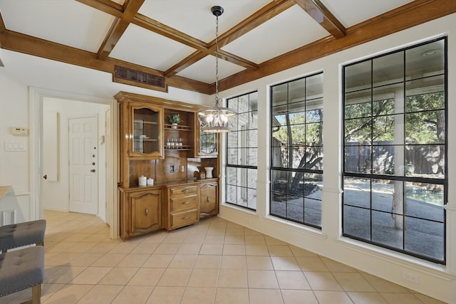 interior space with beamed ceiling, light tile patterned floors, coffered ceiling, and a chandelier