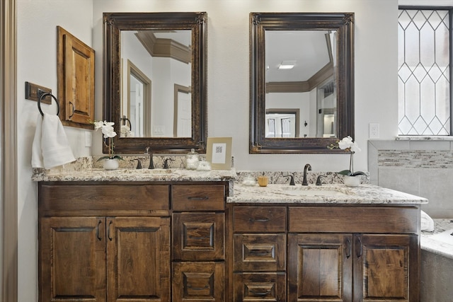 full bath with double vanity, ornamental molding, and a sink