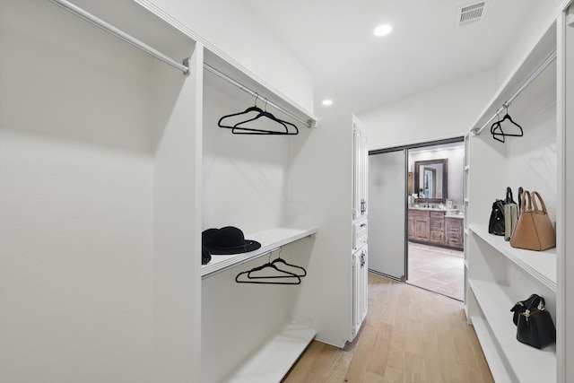 walk in closet featuring visible vents and light wood-style flooring