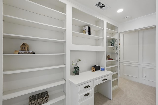 office space with light carpet, visible vents, recessed lighting, and built in desk