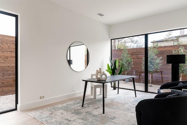 home office featuring baseboards, visible vents, and light wood-type flooring