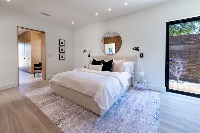 bedroom with light wood-style flooring, recessed lighting, baseboards, and visible vents