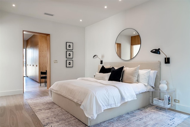 bedroom featuring visible vents, recessed lighting, baseboards, and wood finished floors