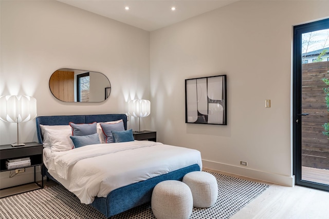 bedroom with access to outside, recessed lighting, light wood-style floors, and baseboards