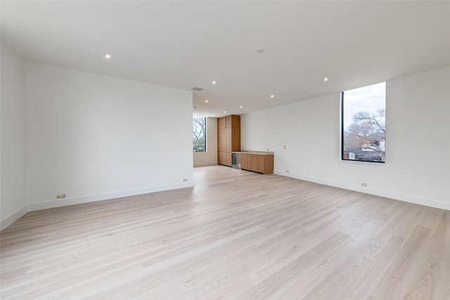 unfurnished room featuring recessed lighting, visible vents, baseboards, and light wood finished floors