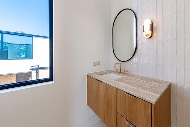 bathroom featuring tile walls and vanity