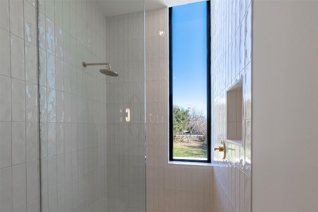 bathroom with tiled shower