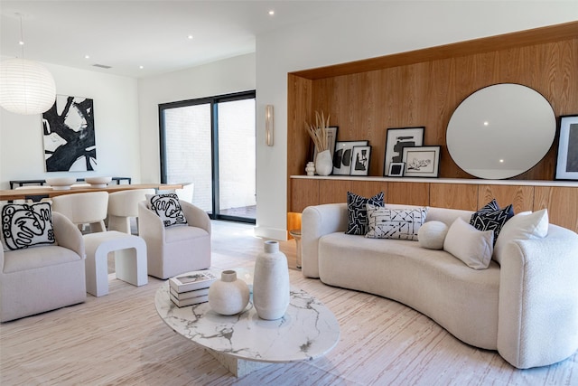 living area featuring wood finished floors, recessed lighting, and visible vents