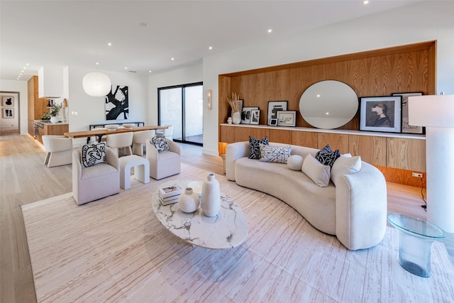 living area with recessed lighting and light wood finished floors