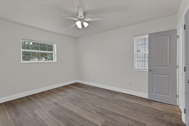 unfurnished room with wood finished floors, baseboards, and ceiling fan